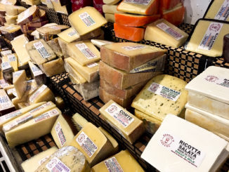 A variety of cheeses are on display.