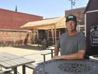 Kevin Lutz sits on patio outside Stoney's Rockin' Rodeo.