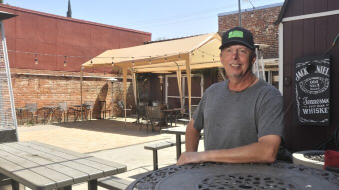 Kevin Lutz sits on patio outside Stoney's Rockin' Rodeo.