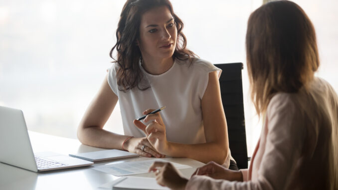 Two women meet in an office