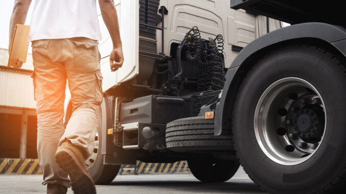 A truck driver walks to his rig