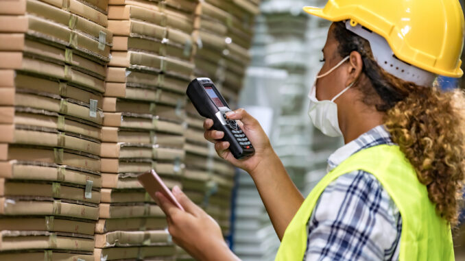 A woman works in a warehouse