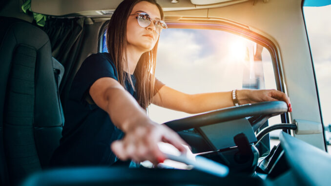 A truck driver in her rig