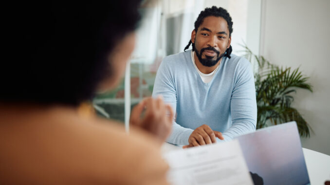 Two people meet in an office