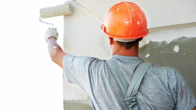 A man paints a wall