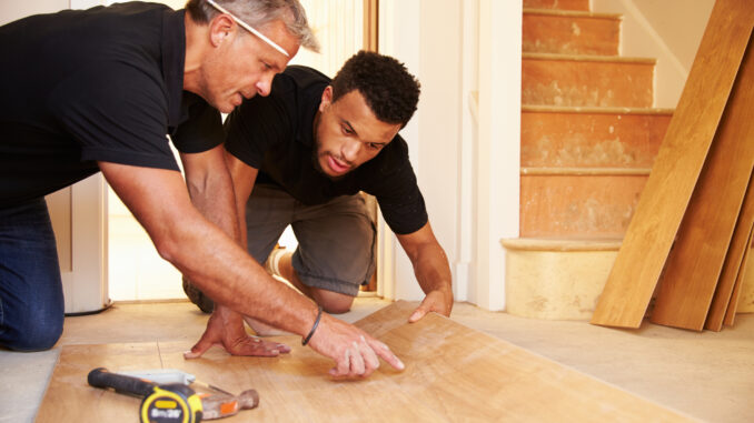 Men put in wood flooring