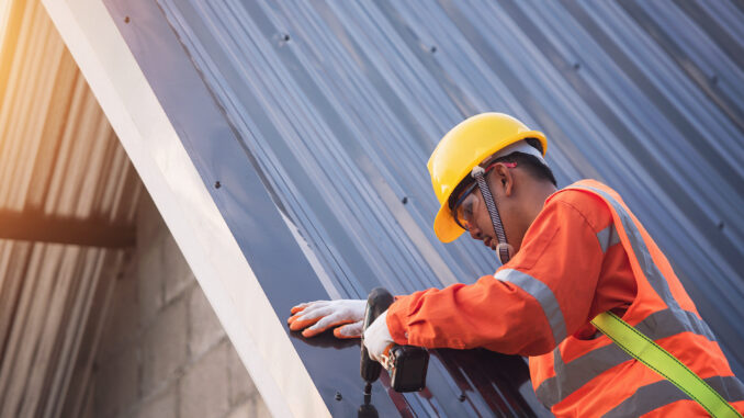 A man installs a new roof