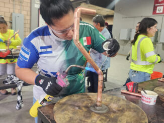 Nidia Chicas working with heavy machinery in a workshop