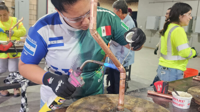 Nidia Chicas working with heavy machinery in a workshop