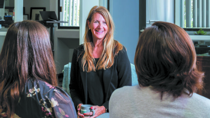 A photo of Tina Atherall speaking with clients