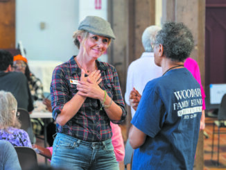 Shairi Engle chats with a choir member during lunch after a Voices of Our City choir rehearsal at St. Paul’s Cathedral