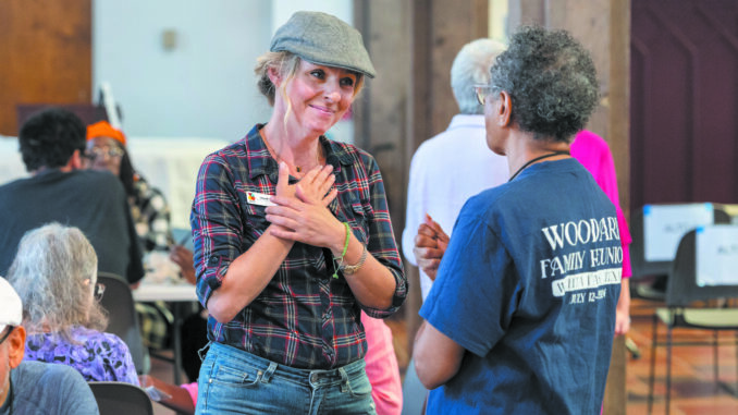 Shairi Engle chats with a choir member during lunch after a Voices of Our City choir rehearsal at St. Paul’s Cathedral