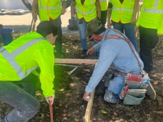 Santiago Pino providing hands-on cement masonry training to ValleyBuild participants.