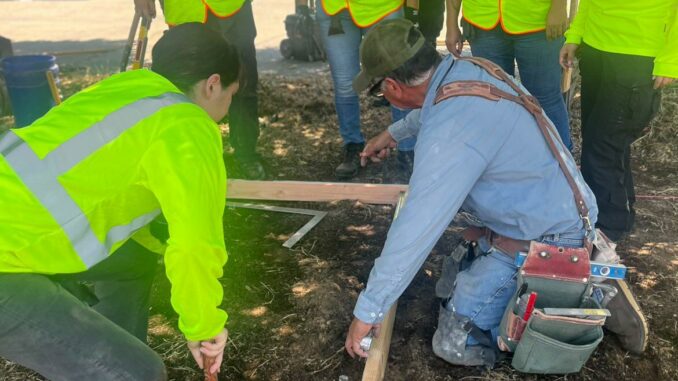 Santiago Pino providing hands-on cement masonry training to ValleyBuild participants.