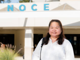 Eunice Worrel-Santos standing in front of the North Orange Continuing Education building