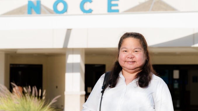 Eunice Worrel-Santos standing in front of the North Orange Continuing Education building