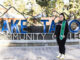 Lina Caro Flores standing in front of the Lake Tahoe Community College sign