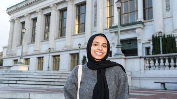 Aneesa Mustafa standing outside and smiling for the camera