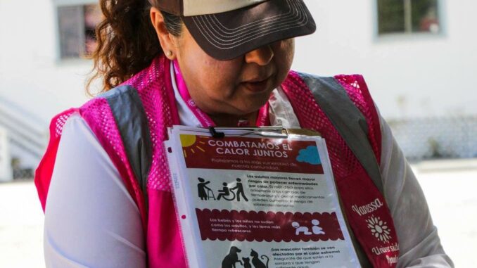 A Valley Civic Committee member looking down at an informative sheet about extreme heat