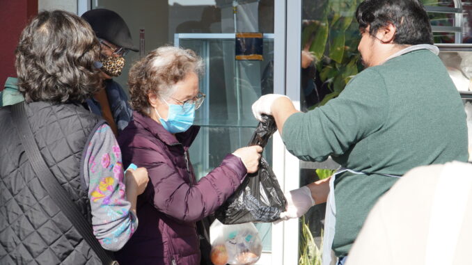 St Barnabas Employee helping senior citizens