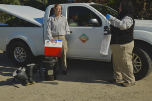 Two MVMD employees with mosquito traps