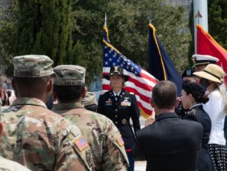 Erica Courtney in dress uniform speaking to uniformed service members