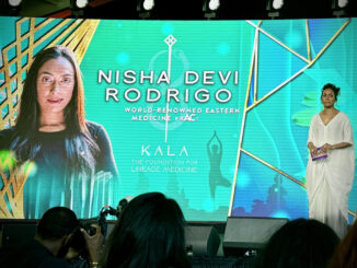 Nisha Devi Rodrigo's photo on a large screen during a presentation.