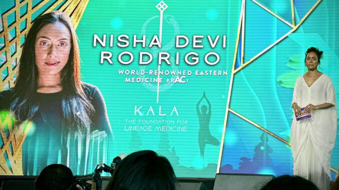 Nisha Devi Rodrigo's photo on a large screen during a presentation.